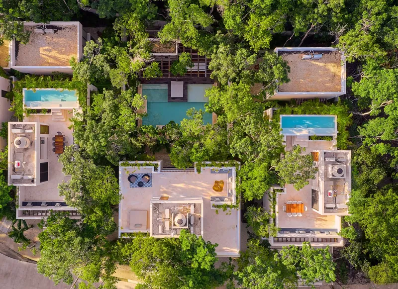 The three KAAN villas of Aldea Kaan Tulum from above: two rooftop pools and one ground floor pool among the jungle trees of La Privada