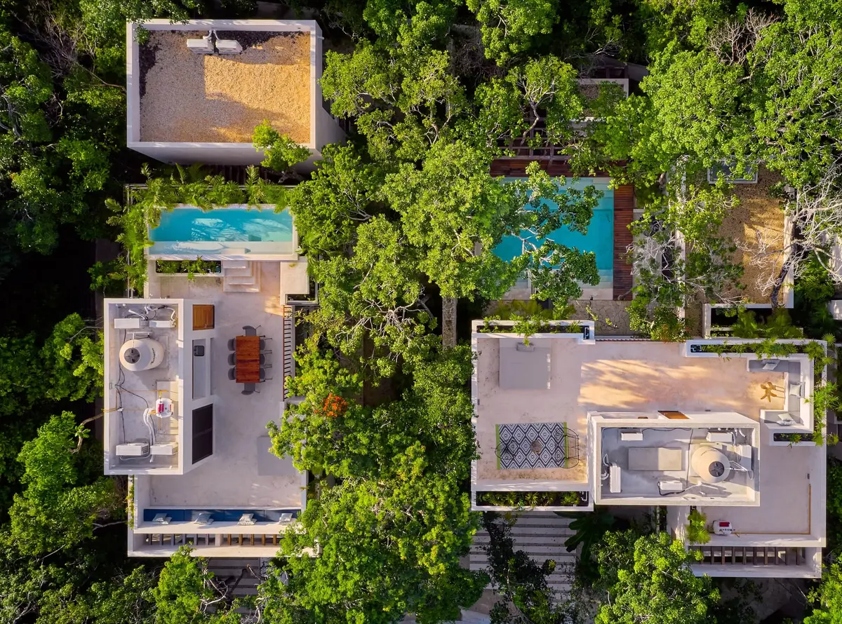 The two KAAN II villas of Aldea Kaan Tulum from above: one rooftop pool and one ground floor pool among the jungle trees of La Privada